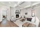 Cozy living room showcasing fireplace, shiplap accent wall, tray ceiling, and neutral decor, with hardwood floors at 267 Triple Ponds Ct # 11, Clover, SC 29710