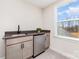 Wet bar featuring a modern sink, a stainless steel dishwasher, and gray cabinetry at 267 Triple Ponds Ct # 11, Clover, SC 29710