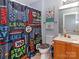 Vibrant bathroom featuring a gaming-themed shower curtain, vanity, and playful decor, designed for  at 3000 Misty Harbor Cir # F, Cramerton, NC 28032