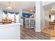 Open-concept dining area with stylish gray flooring, blue cabinets, and a breakfast bar at 3000 Misty Harbor Cir # F, Cramerton, NC 28032