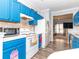 Well-lit kitchen featuring blue cabinets and modern appliances, leading into a comfortable living area at 3000 Misty Harbor Cir # F, Cramerton, NC 28032