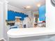 Bright kitchen features custom blue cabinetry, white appliances, and a cozy breakfast bar at 3000 Misty Harbor Cir # F, Cramerton, NC 28032