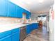 Well-lit kitchen with blue cabinets, stainless steel dishwasher, and eat in nook at 3000 Misty Harbor Cir # F, Cramerton, NC 28032