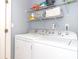 Practical laundry area featuring a washer and dryer and storage shelves at 3000 Misty Harbor Cir # F, Cramerton, NC 28032