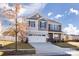 Charming two-story home with a two-car garage, landscaped yard, and a mix of stone and siding exterior at 7607 Nolen Farm Dr, Gastonia, NC 28056