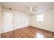 This bedroom features hardwood floors, a ceiling fan, and a closet at 123 23Rd Nw St # E, Hickory, NC 28601
