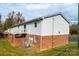 Rear building elevation features brick foundation and fenced in back porches at 123 23Rd Nw St # E, Hickory, NC 28601