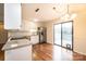 Well-lit kitchen with stainless steel appliances, granite countertops, white cabinets and sliding glass door at 123 23Rd Nw St # E, Hickory, NC 28601