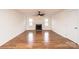 Large living room features wood-look flooring, neutral walls and a cozy fireplace at 123 23Rd Nw St # E, Hickory, NC 28601