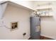 Utility room featuring water heater, shelving and laminate flooring at 123 23Rd Nw St # E, Hickory, NC 28601