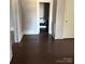 Dark wood floor hallway with access to bathroom at 1808 Taylor Ave, Charlotte, NC 28216