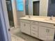 Stylish bathroom featuring dual vanities with sleek white cabinetry and elegant marble flooring at 2615 Tillman St, Monroe, NC 28112