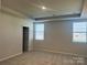 Spacious bedroom featuring neutral carpeting and a tray ceiling, creating a serene and comfortable retreat at 2615 Tillman St, Monroe, NC 28112