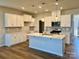 Modern kitchen with white cabinets, stainless steel appliances, an island, and pendant lighting at 2615 Tillman St, Monroe, NC 28112