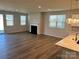 Bright living room boasts a fireplace and flows into the kitchen with wood flooring and ample natural light at 2615 Tillman St, Monroe, NC 28112