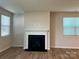 Bright living room with a cozy fireplace and large windows, perfect for relaxing or entertaining guests at 2615 Tillman St, Monroe, NC 28112