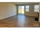 Spacious living room with a sliding glass door to the backyard, laminate floors, and a fireplace at 2615 Tillman St, Monroe, NC 28112