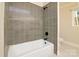 Clean bathroom with grey tile and a bathtub at 3804 Singletree Rd, Mint Hill, NC 28227