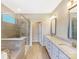 Bathroom with double sink vanity, soaking tub and frameless glass shower enclosure at 127 Jentri Way, Mooresville, NC 28115