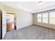 Bedroom with carpeted floors and several windows for natural light at 127 Jentri Way, Mooresville, NC 28115