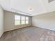 Bedroom with carpeted floors and several windows for natural light at 127 Jentri Way, Mooresville, NC 28115