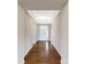 Inviting hallway with hardwood floors and decorative tray ceiling leading to the front door at 127 Jentri Way, Mooresville, NC 28115