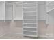 Large walk-in closet with custom shelving and hanging rods at 13401 Centennial Commons Pkwy, Huntersville, NC 28078