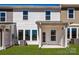 Backyard view of a white, two-story home with well-maintained lawn and an outdoor patio at 153 Halite Ln, Waxhaw, NC 28173