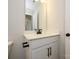 Modern bathroom vanity featuring black hardware, a bright mirror, and under-sink storage at 153 Halite Ln, Waxhaw, NC 28173