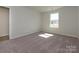 Bright bedroom with a large window, plush carpeting, and neutral walls providing a serene space at 153 Halite Ln, Waxhaw, NC 28173
