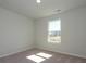 Cozy bedroom with neutral carpet and a window offering natural light and outside views at 153 Halite Ln, Waxhaw, NC 28173