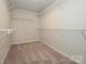 Spacious walk-in closet featuring carpeted floors and wire shelving for optimal storage at 153 Halite Ln, Waxhaw, NC 28173