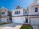 New construction townhome with a two car garage, stone accents and a welcoming front door at 153 Halite Ln, Waxhaw, NC 28173