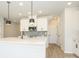 Modern kitchen featuring a large island, white cabinetry, sleek fixtures, and stainless steel appliances at 153 Halite Ln, Waxhaw, NC 28173