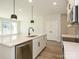 Open-concept kitchen featuring a large island with stainless steel appliances and modern finishes at 153 Halite Ln, Waxhaw, NC 28173