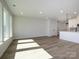 Living room with hardwood floors and lots of natural light; open concept to kitchen at 153 Halite Ln, Waxhaw, NC 28173