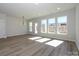 Open living room features lots of natural light, hardwood flooring, and views of the neighborhood at 153 Halite Ln, Waxhaw, NC 28173