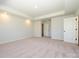 Spacious primary bedroom with plush carpet, an ensuite bathroom, and closet access at 153 Halite Ln, Waxhaw, NC 28173