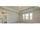 Primary bedroom with carpet, tray ceilings, and natural light at 153 Halite Ln, Waxhaw, NC 28173