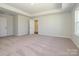 Primary bedroom featuring plush carpet, tray ceilings, and ensuite bath access at 153 Halite Ln, Waxhaw, NC 28173