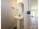 Powder room featuring a pedestal sink and hardwood floors at 153 Halite Ln, Waxhaw, NC 28173