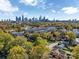Panoramic aerial view of city skyline and townhome community surrounded by lush greenery and colorful trees at 582 West End Dr, Charlotte, NC 28208