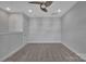 Simple bedroom featuring neutral walls and carpet, complemented by a modern ceiling fan at 582 West End Dr, Charlotte, NC 28208