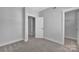 Neutral carpeted bedroom featuring a walk-in closet and a doorway that leads to another room at 582 West End Dr, Charlotte, NC 28208