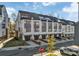 Modern townhomes with individual garages, well-manicured lawns, and contemporary architectural details at 582 West End Dr, Charlotte, NC 28208