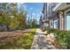 Modern townhomes feature sleek exterior design with individual entrances, small balconies, and landscaped walkways at 582 West End Dr, Charlotte, NC 28208