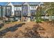 Modern townhomes with gray siding, balconies, and beautifully landscaped front yard at 582 West End Dr, Charlotte, NC 28208