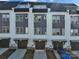 Modern townhomes with individual garages and driveways, presenting a cohesive street view at 582 West End Dr, Charlotte, NC 28208