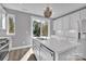 Bright kitchen featuring white cabinets, quartz countertops, and modern fixtures at 582 West End Dr, Charlotte, NC 28208