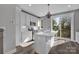 Well-lit kitchen with a center island, stainless steel appliances, and gray walls at 582 West End Dr, Charlotte, NC 28208